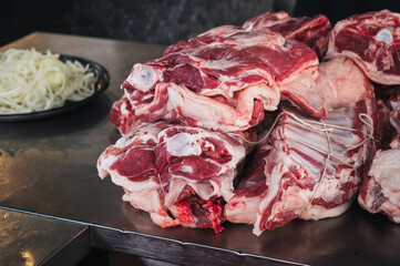 Fresh raw lamb meat on counter for cooking traditional Asian Uzbek pilaf in the restaurant Besh Qozon in Tashkent in Uzbekistan