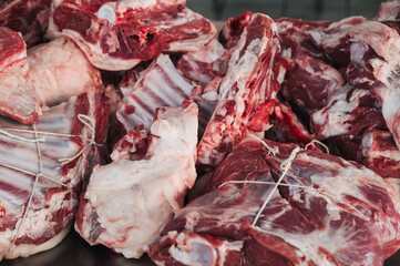 Fresh raw lamb meat on the counter for cooking traditional Asian Uzbek pilaf in bazaar in Tashkent in Uzbekistan