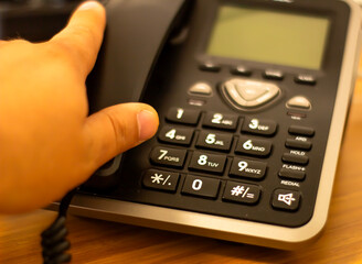Close up soft focus on telephone devices at office desk with light effect,communication technology...