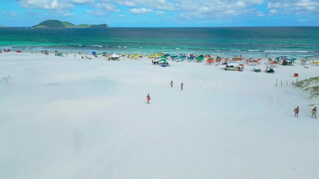 Aerial view of Varadero beach with tourists relaxing under colorful umbrellas on white sand in Cuba.