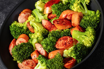 fried juicy sausage and crispy broccoli in skillet