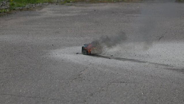 Home appliance Lio Ion battery pack burning with explosion outdoor slowmotion
