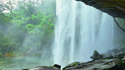 Serene cave oasis: Waterfall cascading in lush tropical paradise, nature's masterpiece of beauty...