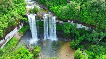 In the heart of a lush, tropical paradise, a captivating waterfall sets the stage for love's embrace, its beauty a testament to the magic of nature. Huai Luang Waterfall, Thailand. Drone view.
