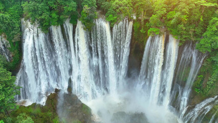 The dense tropical rainforest hides a spectacular secret: a grand waterfall. A drone's lens unveils...