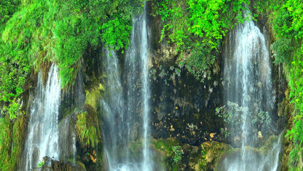 Discover harmony in nature's triple cascade, tucked away in a vibrant rainforest. Drone view...