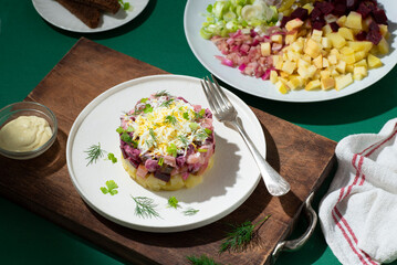 Rosolje -  Estonian beet and herring salad or Rosoli Finland salad with boiled beets, potatoes,...