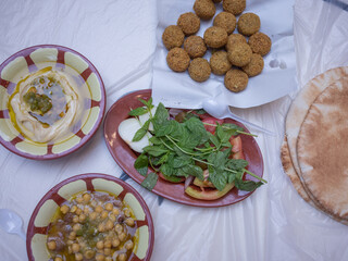 traditional arabic breakfast; hummus, falafel, foul, etc. on the table of the restaurant in capital amman