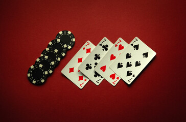 Four sevens in a poker game is a winning combination of four of a kind or quads on a red table in a club