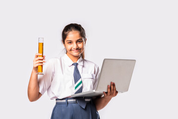 Cute little Indian asian schoolgirl studying chemistry with chemical in glass flask and laptop