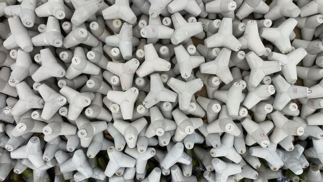 Aerial view of concrete tetrapod. Concrete tetrapods line. Coastal protection. Wave breakers