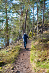 A man walking on forest trail near lake Vattern Motala Sweden