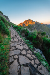 Hiking on the highest peak of Madeira Pico Ruivo next to the cottage Abrigo do Pico Ruivo. Views of the surrounding mountains lanscape during sunrise