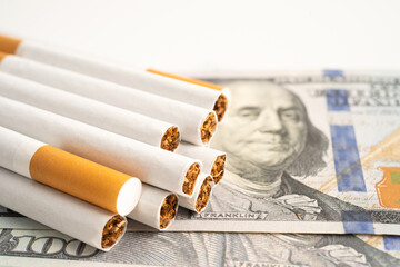 Cigarette on US dollar banknotes, cost, trading, marketing and production, No smoking.