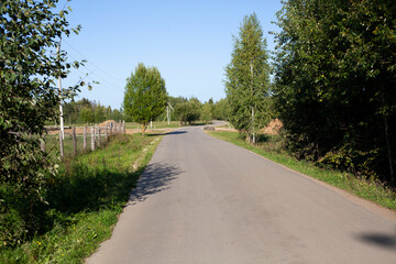 The Road to the Farm. Highway in the countryside. Narrow road in summer.