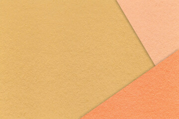 Fototapeta premium Texture of craft dark yellow paper background with peach and coral border. Vintage abstract ocher cardboard.