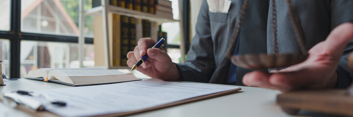 A lawyer or legal advisor prepares to sign legal contract documents. Managing a business with one...