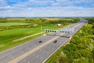 Aerial photo of the motorway in the UK known as the M1along side farmers fields on a beautiful...