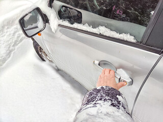 Frozen Car Lock on a Cold Winter Day. Woman person attempts to unlock a frozen car door. Problem...