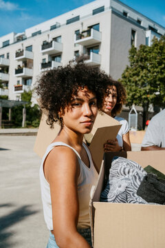 Portrait of female volunteer with curly hair during charity drive at community center