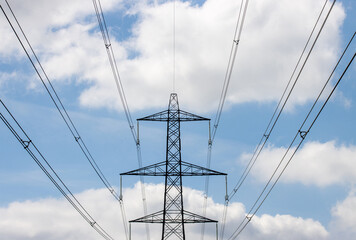 Photo of an electronic pylon on a blue sky day with a few clouds in the sky