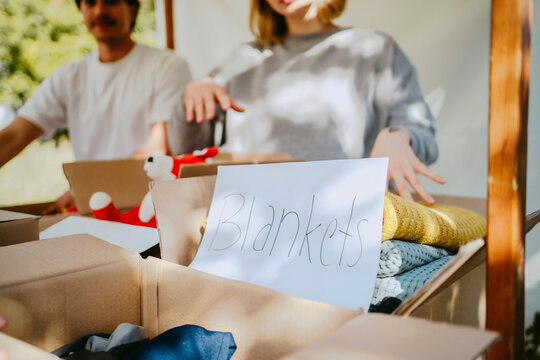Blankets name tag near donation boxes at community center
