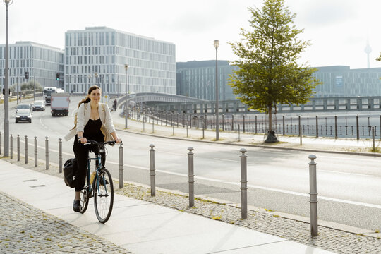 Businesswoman commuting on cycle in city