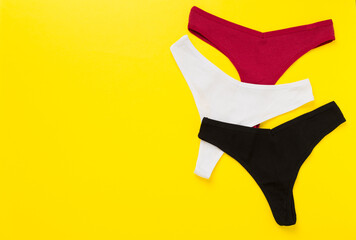 Women's cotton panties on color background, top view