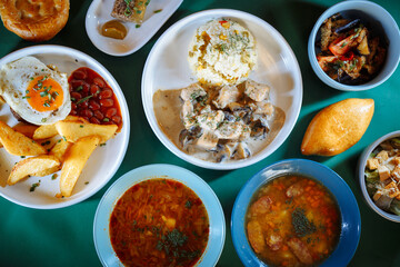 Top view of delicious and healthy food on the green table.