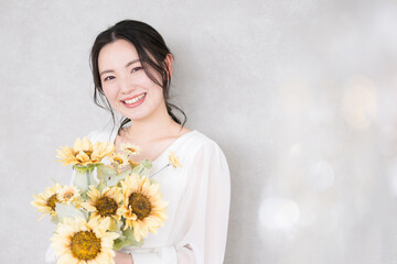 Cute bride with sunflower bouquet Bridal, beauty and pre-shoot images Looking at the camera