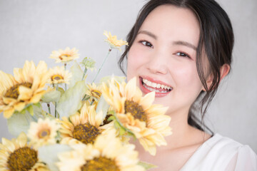 Cute woman with sunflower bouquet Close-up of a cute image for bridal, beauty or pre-shoots Looking...