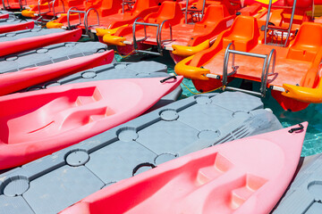 Row of plastic red kayaks