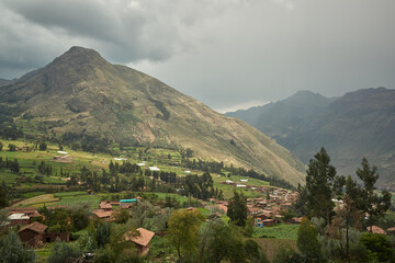 Majestic green mountain range with village houses and trees Peru