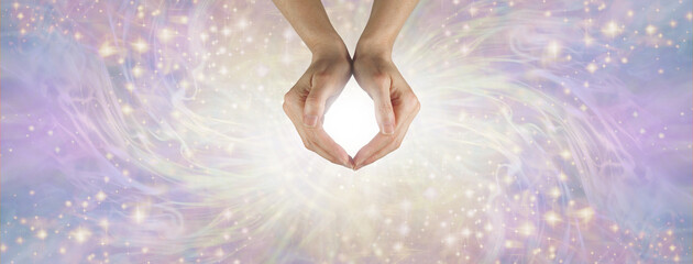 Reiki Master demonstrating beautiful energy message background - female hands forming an O with...