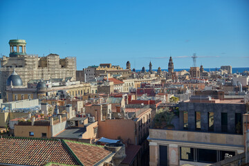 View of rooftops out to sea of buildings and houses in Barcelona Spain