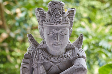 Fototapeta na wymiar Close up of stone Buddhist or Hindu statue with fine detail