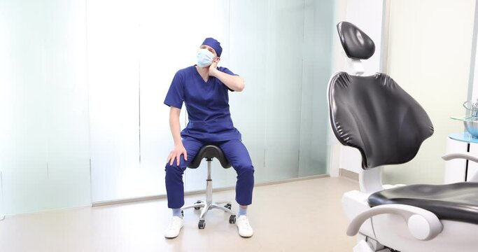 Sitting dentist, dealing with neck pain.Symptoms and self help exercises, stretching.  front view.