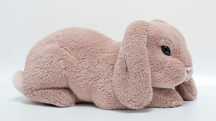Soft toy rabbit laying on the ground - Powered by Adobe