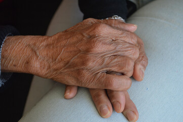 a hands of a woman and an old woman