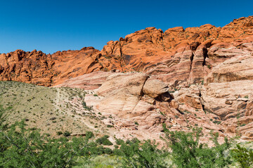 Fototapeta premium a view to the colorful red and yellow shining rock formations in the Red rock Canyon, Nevada 
