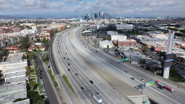 Landscape view of Los Angeles city skyline - descending aerial over 110 Pasadena freeway
