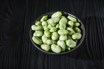 fresh greens broad beans fava on a dark background