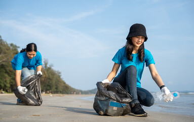 Group teamwork volunteer pick up the plastic bottle on the beach. People male and female Volunteer...