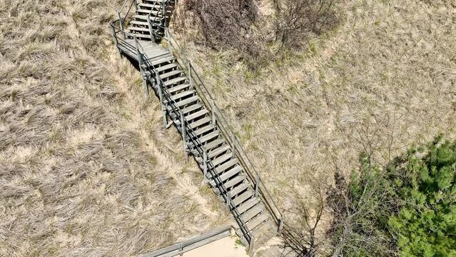 Stairs ascending deep into the cresting dunes.