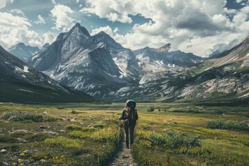 Lone hiker trekking towards majestic mountains, capturing vast landscape