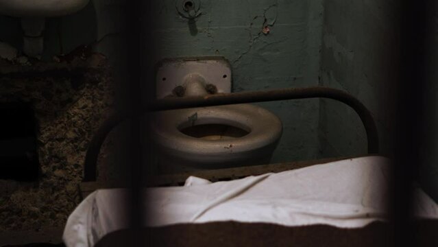 Alcatraz Prison Detail, Interior of Prison Cell With Escape Hole in Wall, Bed, Rustic Sink and Toilet, View Behind Bars