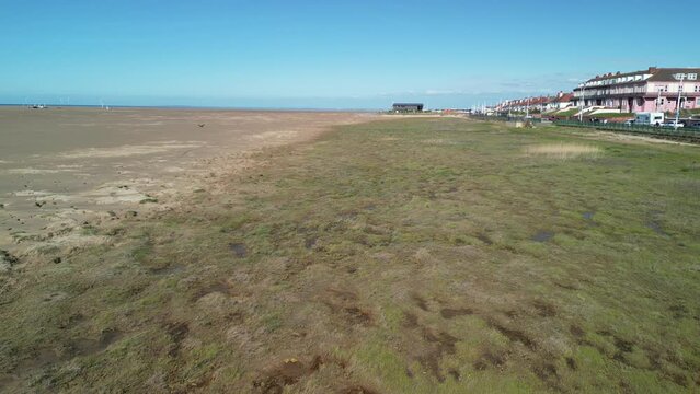 Hoylake Beachfront conservation area - aerial drone low flyover Spartina grass towards Meols, Wirral, UK