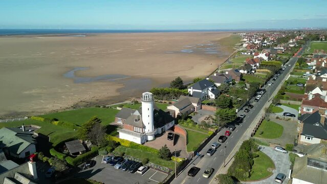 Converted lighthouse, Hoylake Beachfront - aerial drone anti-clockwise slow rotate, Wirral, UK