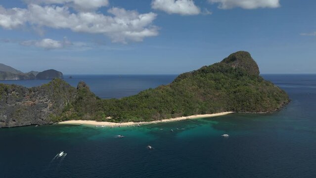 Long push back aerial shot of Helicopter island in El Nido, Philippines.