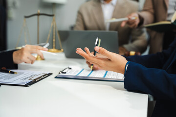 Business people and lawyers discussing contract papers sitting in the table at office in the...